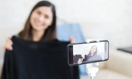 Fashion influencer reviewing clothing items